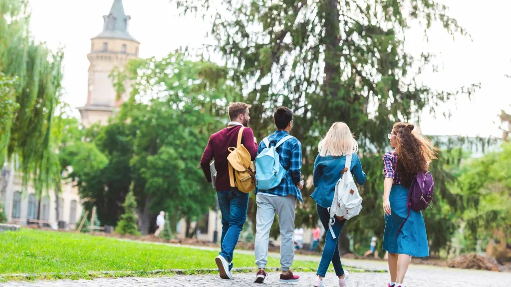 A group of students walking outside on a college campus